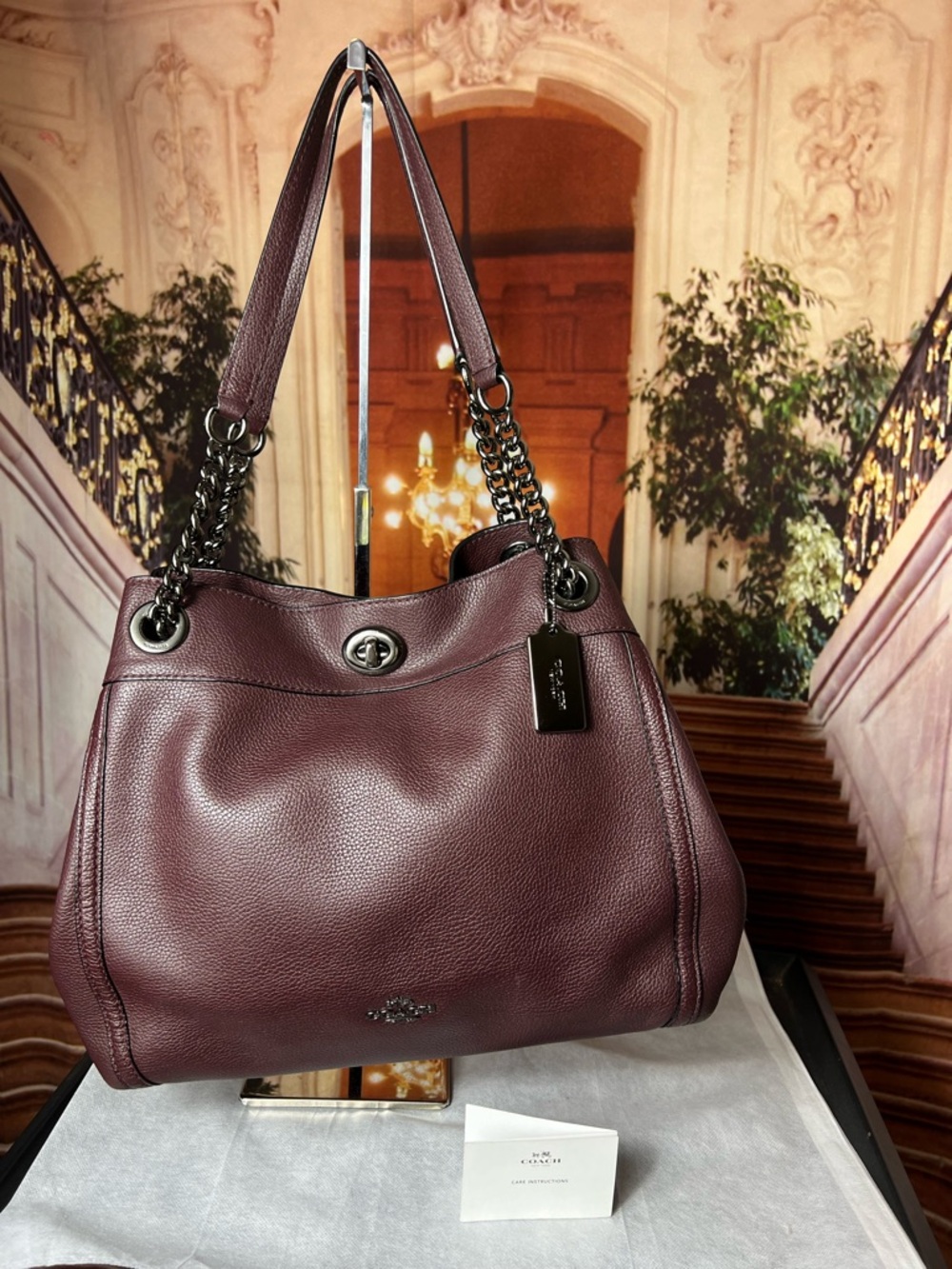 Coach Turnlock Edie shoulder bag crafted from dark berry polished pebble leather